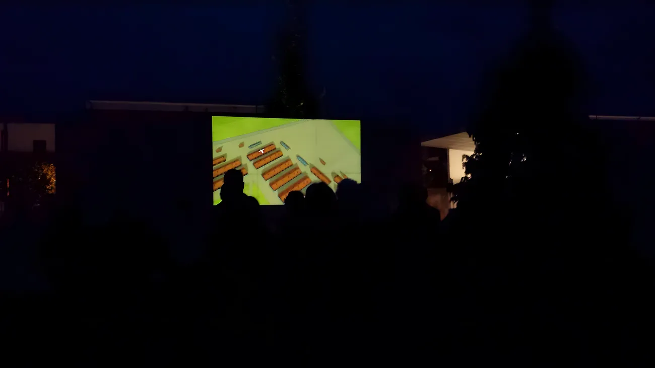 The audience in silhouette watching the son-et-lumière at nightfall